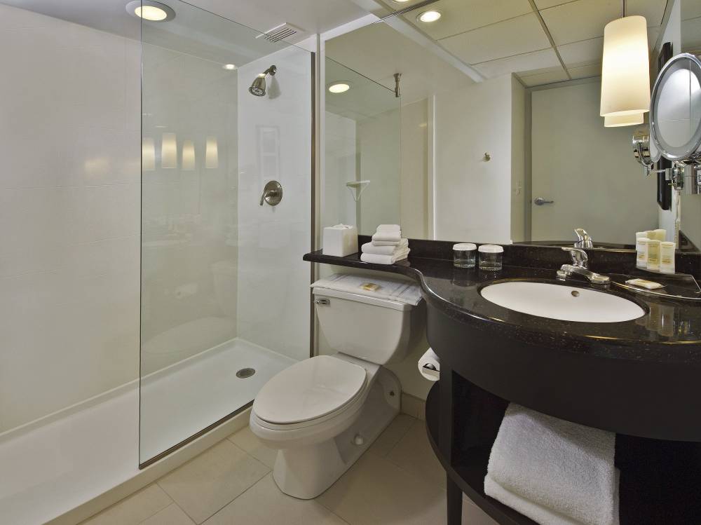 Spacious, marble-finished bathroom with separate b